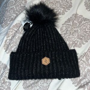 Volcom Lula Beanie one size fits all.  NWT black with furry ball on top.